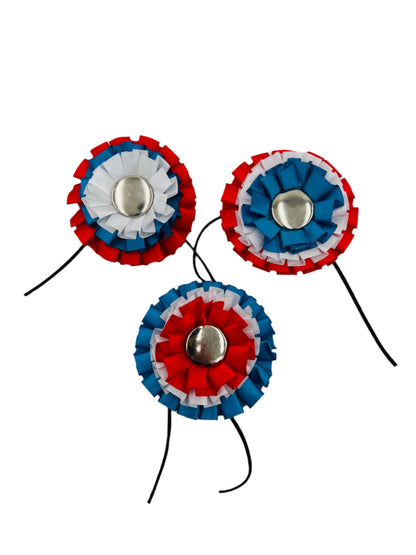 Front view of a Tricolor Colonial Hat Cockade, featuring pleated ribbons in red, white, and blue with a central silver-tone accent, ideal for adorning tricorn hats and completing colonial-style uniforms.